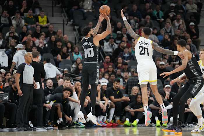 Dec 26, 2023; San Antonio, Texas, USA; San Antonio Spurs forward Julian Champagnie (30) shoots over Utah Jazz forward John Collins (20) in the first half at the Frost Bank Center.